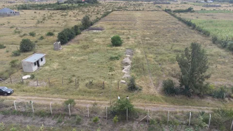 Drone view of fenced Alma Gardens plots and access roads