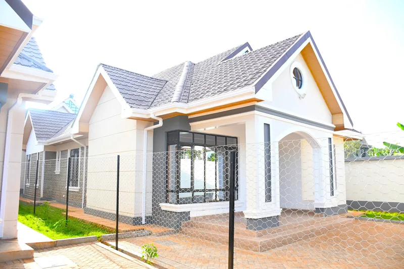 Casa Bonita 3-bedroom bungalow with gabled roof, round window and paved compound