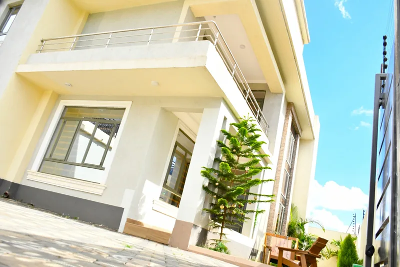 Crimson Bay mansionette with large windows and landscaped entrance
