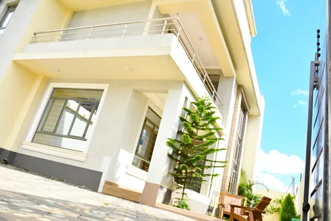 Crimson Bay mansionette with large windows and landscaped entrance