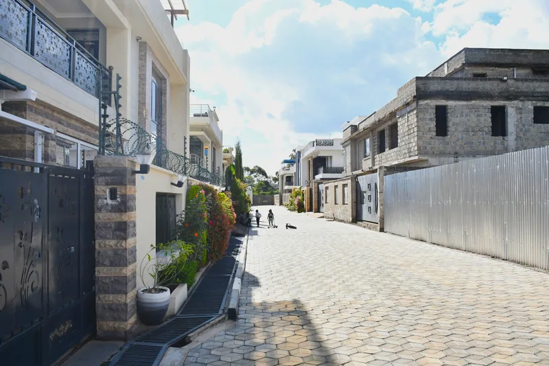 Street view of Crimson Bay villas with perimeter walls and gates