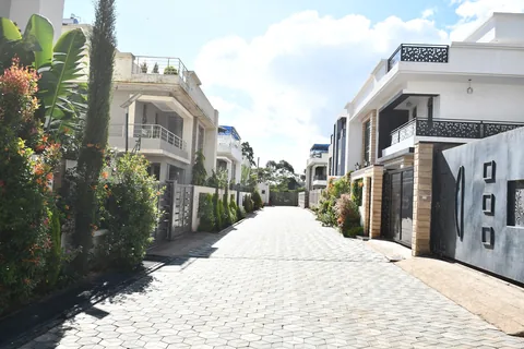 Cabro-paved internal road lined with Crimson Bay villas and greenery