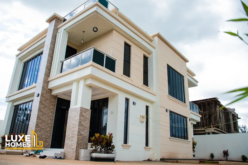 Neema Court 5-bedroom maisonette with stone-clad columns, glass balcony and large black-framed windows
